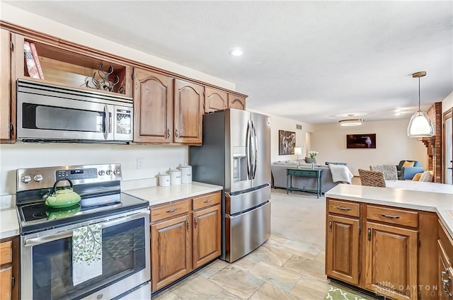 kitchen with brown cabinets, appliances with stainless steel finishes, open floor plan, and light countertops