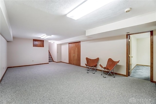 unfurnished room with stairway, baseboards, carpet, and a textured ceiling