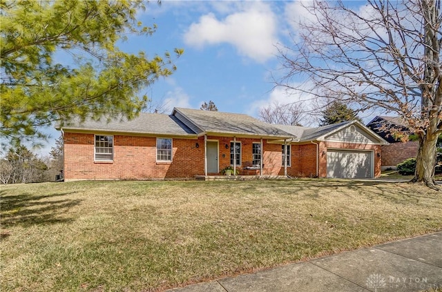 single story home with a front yard, a garage, covered porch, and brick siding