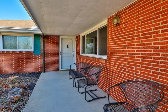 doorway to property with brick siding