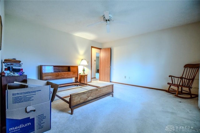 living area with baseboards, carpet floors, and ceiling fan