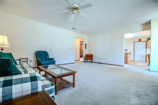 carpeted living room featuring a textured ceiling, a ceiling fan, visible vents, and baseboards