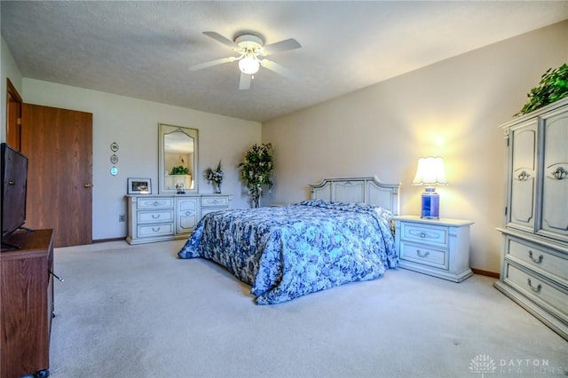 bedroom with light colored carpet, baseboards, and a ceiling fan