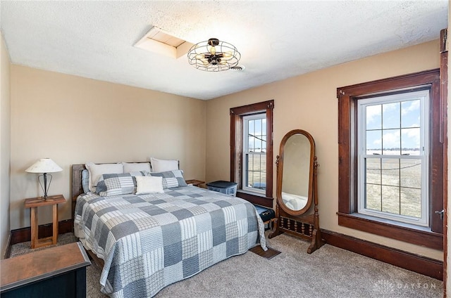 bedroom featuring baseboards, a textured ceiling, and carpet flooring