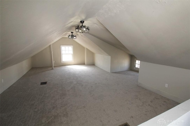 bonus room featuring visible vents, lofted ceiling, and carpet flooring