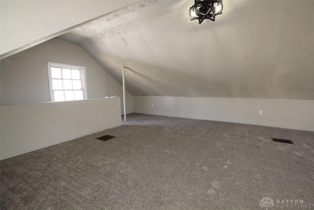 bonus room featuring visible vents, lofted ceiling, and carpet