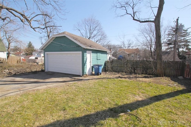 detached garage featuring fence