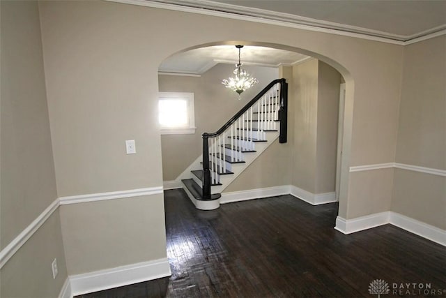 interior space featuring stairway, baseboards, hardwood / wood-style floors, and crown molding