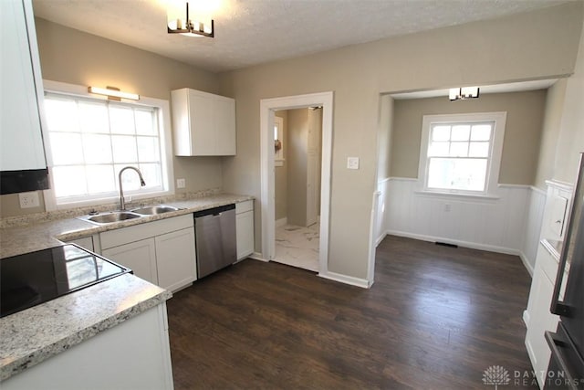 kitchen with a sink, dark wood-type flooring, a wainscoted wall, white cabinetry, and stainless steel dishwasher