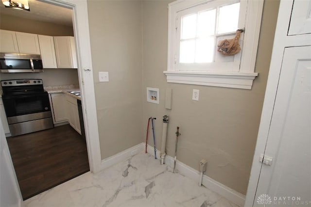 laundry room featuring washer hookup, baseboards, and marble finish floor