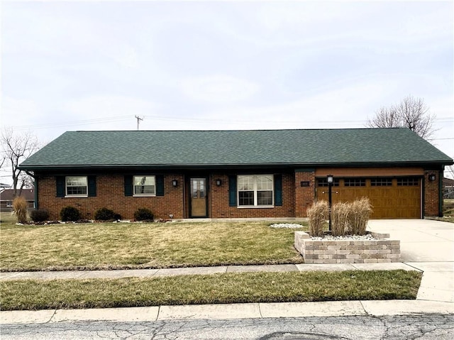 ranch-style home with brick siding, a garage, concrete driveway, and a front yard