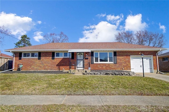 ranch-style home featuring a front lawn, an attached garage, brick siding, and driveway