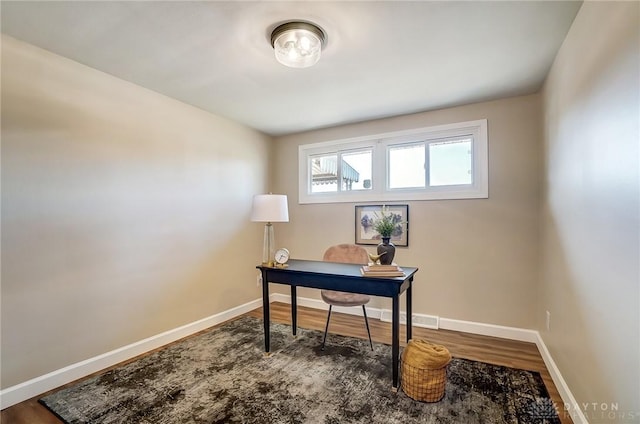 office space with visible vents, wood finished floors, and baseboards