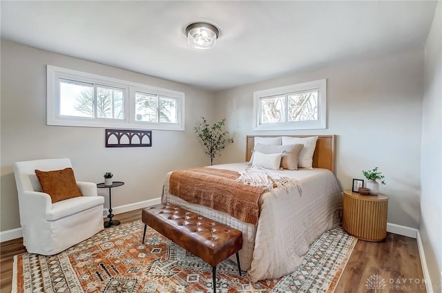 bedroom with baseboards and wood finished floors