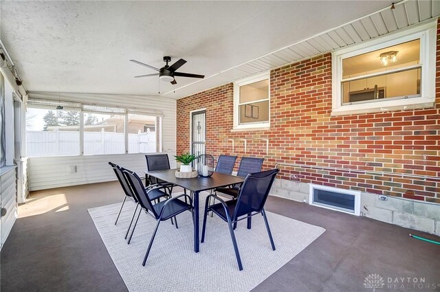 sunroom / solarium with a ceiling fan