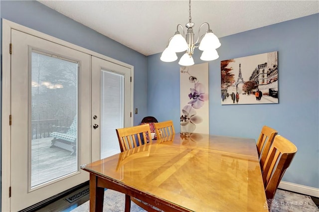 dining room featuring french doors, baseboards, and a chandelier