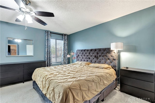 bedroom with carpet floors, a textured ceiling, and ceiling fan