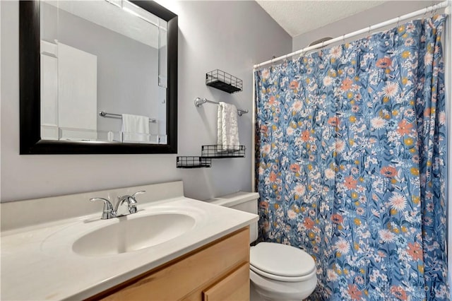 full bath featuring curtained shower, a textured ceiling, toilet, and vanity