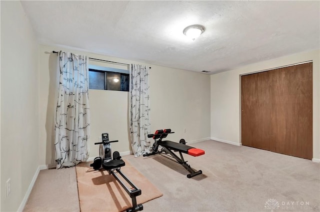 workout room with visible vents, a textured ceiling, baseboards, and carpet floors