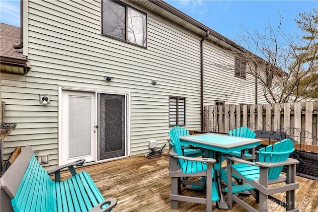 wooden terrace featuring outdoor dining area and fence