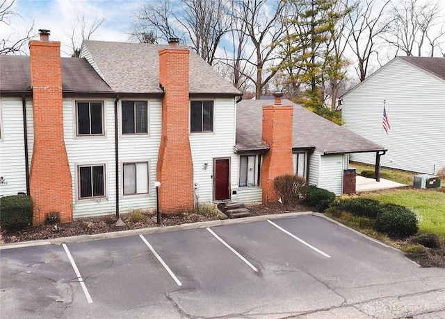 exterior space with central AC and uncovered parking