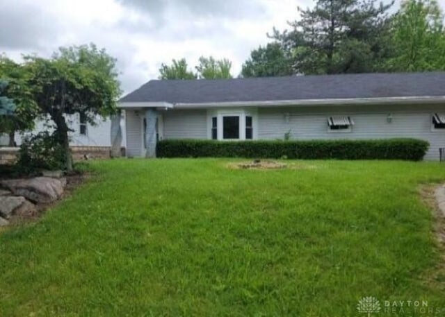 back of property featuring a lawn