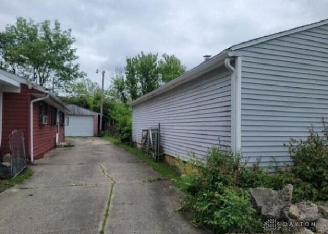 view of side of home with an outbuilding and a garage