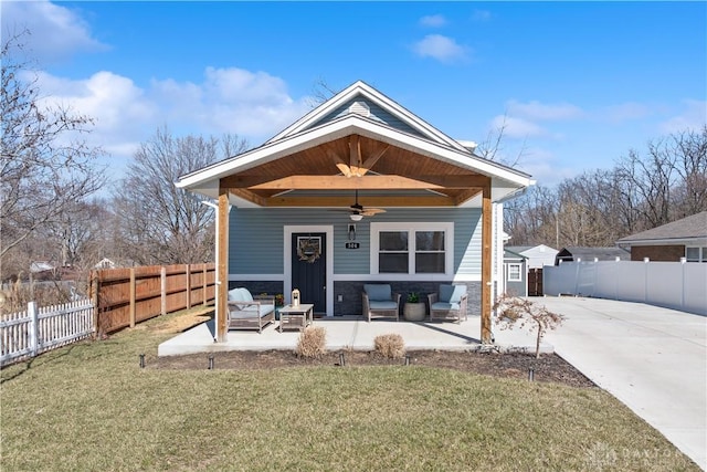 view of front of house featuring a front lawn, a patio area, and ceiling fan