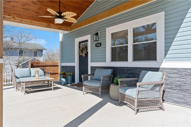 view of patio / terrace featuring an outdoor hangout area, a ceiling fan, and fence