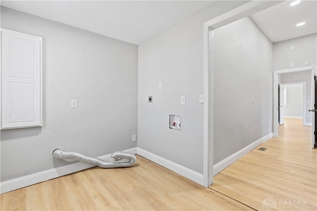 laundry area with light wood-type flooring, baseboards, hookup for an electric dryer, hookup for a washing machine, and laundry area