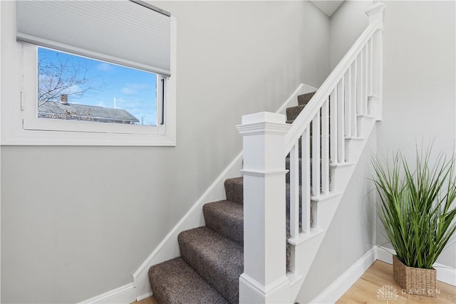 stairs featuring baseboards and wood finished floors