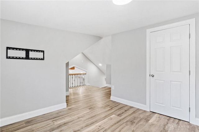 bonus room with wood finished floors and baseboards