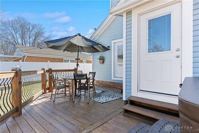 wooden deck with outdoor dining space and fence