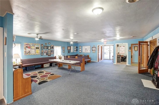 recreation room with carpet floors, plenty of natural light, and a ceiling fan