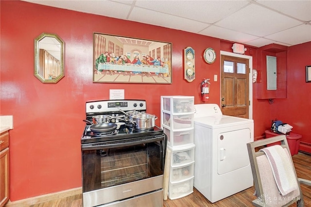 laundry room with electric panel, washer / clothes dryer, light wood-style flooring, and laundry area