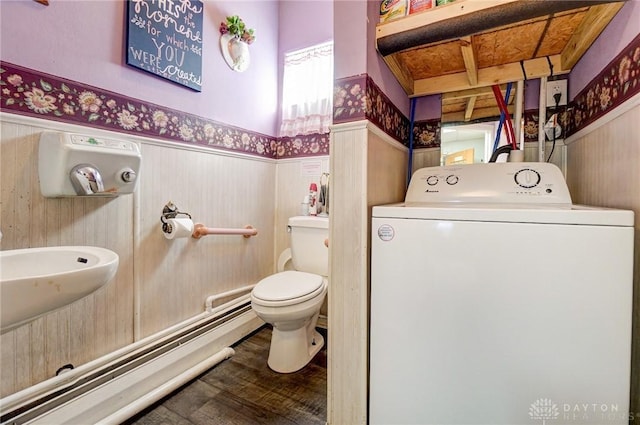 bathroom with toilet, washer / clothes dryer, wood finished floors, and wainscoting