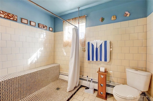 bathroom featuring tile patterned floors, tiled shower, toilet, and tile walls