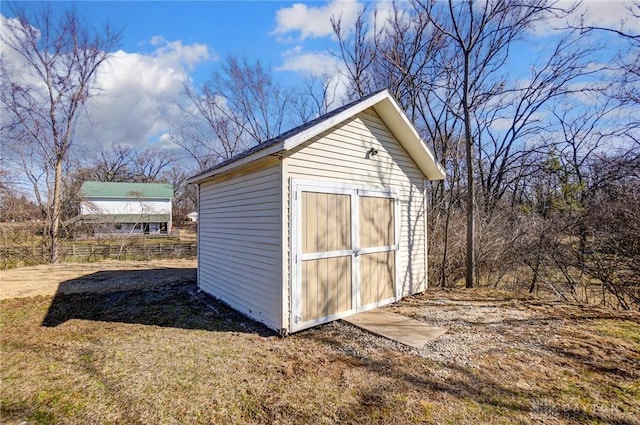 view of shed featuring fence