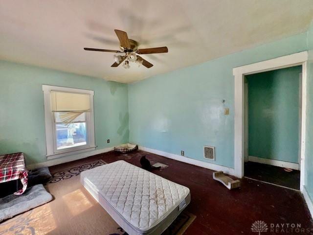 bedroom with visible vents, a ceiling fan, and baseboards