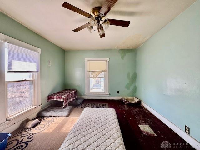 unfurnished bedroom featuring baseboards and ceiling fan