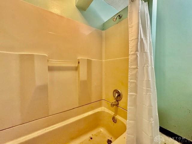 bathroom with shower / bathtub combination with curtain