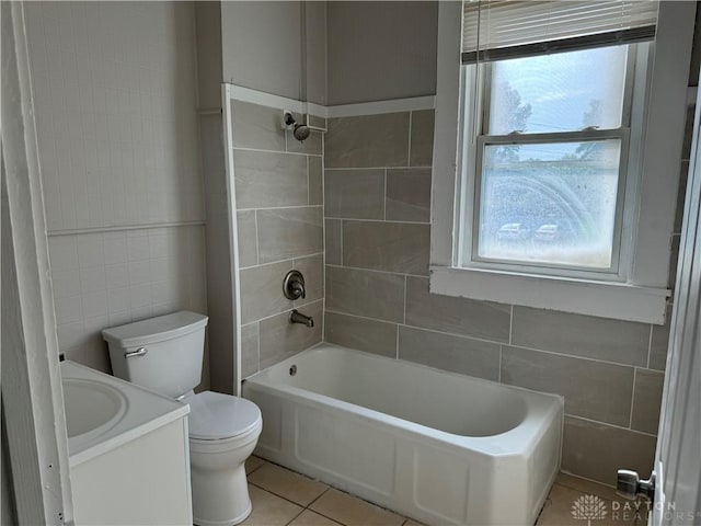 bathroom with tile walls, toilet, shower / bathtub combination, tile patterned floors, and vanity