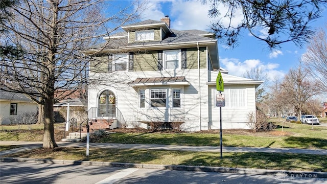 traditional style home with a front lawn and a chimney