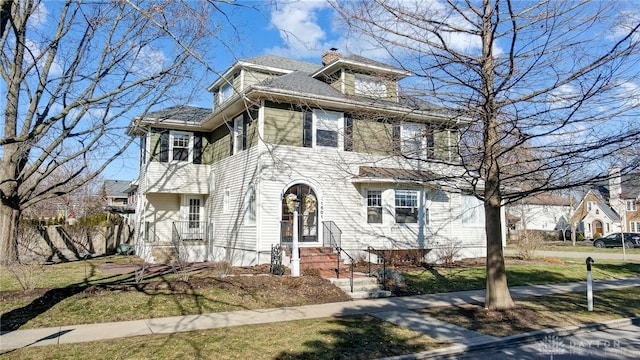 american foursquare style home with a chimney