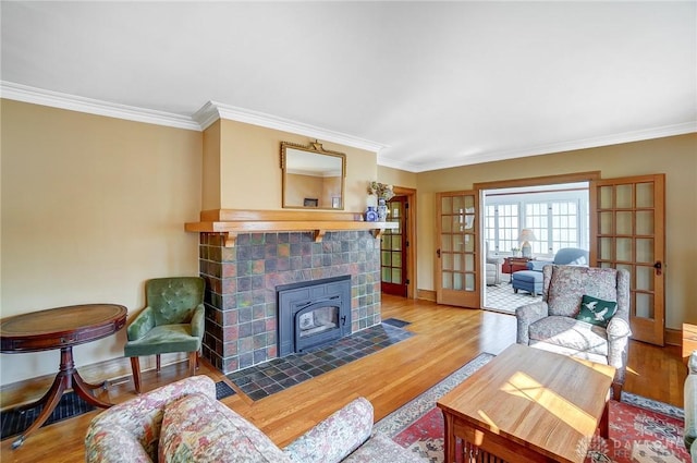 living area featuring wood finished floors, french doors, and ornamental molding