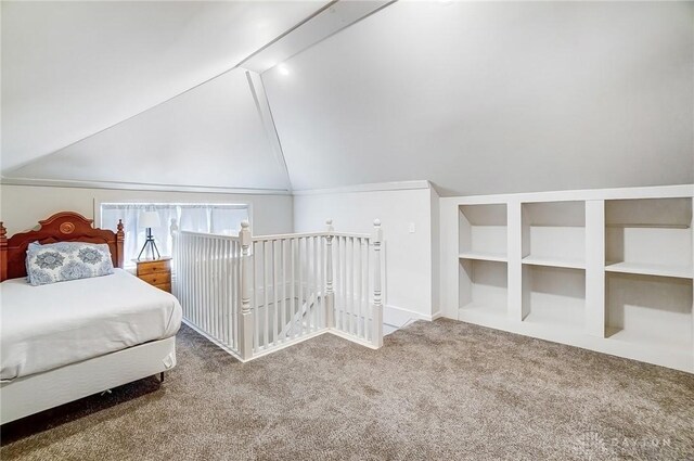 unfurnished bedroom featuring lofted ceiling and carpet