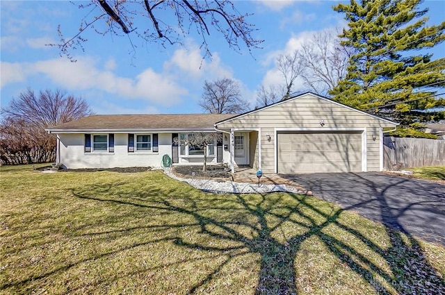 ranch-style home featuring a front yard, fence, a garage, and driveway