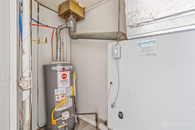 utility room featuring gas water heater