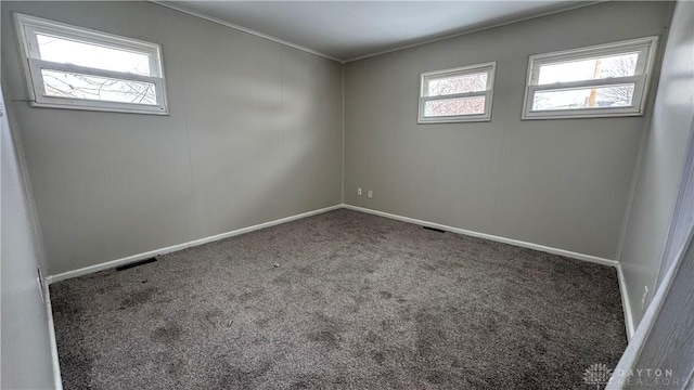 carpeted spare room with baseboards