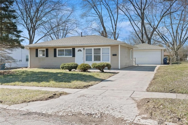 ranch-style home with an outbuilding, a garage, and a front yard